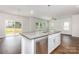 Bright, open kitchen area featuring a sink in the kitchen island and sliding patio doors at 2039 Sadler Woods Ln, Charlotte, NC 28214