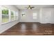 Bright room with large windows, wood-look floors, and ceiling fan at 2039 Sadler Woods Ln, Charlotte, NC 28214