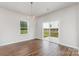 Well-lit living room with wood floors and sliding patio doors at 2039 Sadler Woods Ln, Charlotte, NC 28214