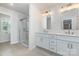 Well-lit main bathroom with dual sinks and a walk-in glass shower at 2039 Sadler Woods Ln, Charlotte, NC 28214