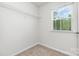 Walk-in closet featuring carpet flooring, wire shelving, and a window at 2039 Sadler Woods Ln, Charlotte, NC 28214