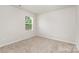 Bedroom featuring carpet floor and a window allowing ample sunlight at 2047 Sadler Woods Ln, Charlotte, NC 28214