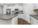 Contemporary kitchen featuring stainless steel appliances, gray countertops, and wood floors at 2047 Sadler Woods Ln, Charlotte, NC 28214