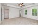 Bright main bedroom features carpet floors, two windows and an adjoining closet space at 2047 Sadler Woods Ln, Charlotte, NC 28214