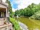 Beautiful lake view from backyard featuring a tranquil fountain and natural surroundings at 2240 La Maison Dr, Charlotte, NC 28226