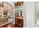 Stylish bar area with mirrored shelves, granite countertops, and a built-in wine cooler at 2240 La Maison Dr, Charlotte, NC 28226