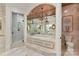 Luxurious bathroom with a soaking tub, chandelier, and separate glass-enclosed shower at 2240 La Maison Dr, Charlotte, NC 28226