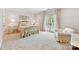 Bright bedroom featuring a bed with gold frame and a chair with a marble side table at 2240 La Maison Dr, Charlotte, NC 28226