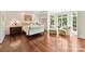 Bright bedroom with hardwood floors, large windows, and a comfortable seating area at 2240 La Maison Dr, Charlotte, NC 28226