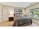Comfortable bedroom with natural light, a bed with decorative pillows, and unique artwork at 2240 La Maison Dr, Charlotte, NC 28226