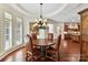 Charming dining room with round table, leather chairs, and a chandelier under a dome ceiling at 2240 La Maison Dr, Charlotte, NC 28226