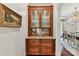 Elegant dining area featuring a built-in china cabinet with granite countertops and detailed woodwork at 2240 La Maison Dr, Charlotte, NC 28226