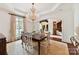 Elegant dining room with a chandelier, formal dining set, and large windows at 2240 La Maison Dr, Charlotte, NC 28226