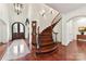 Grand foyer with hardwood floors, a curved staircase, and a decorative rug and chandelier at 2240 La Maison Dr, Charlotte, NC 28226