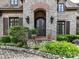 A close-up of the front entrance revealing stone and brick architecture and a decorative wrought iron door at 2240 La Maison Dr, Charlotte, NC 28226