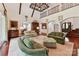 Elegant living room with high ceilings, ornate chandelier, and a wrought iron balcony overlooking the space at 2240 La Maison Dr, Charlotte, NC 28226