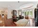 Spacious living room featuring hardwood floors, decorative ceiling, and ample natural light from large windows at 2240 La Maison Dr, Charlotte, NC 28226