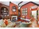 Inviting living room with a fireplace, dark wood beams, built-in bookshelves, and hardwood floors at 2240 La Maison Dr, Charlotte, NC 28226