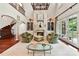 Spacious living room with high ceilings, a fireplace, built-in shelving, and hardwood floors at 2240 La Maison Dr, Charlotte, NC 28226