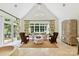 Bright sitting room with vaulted ceilings, large windows, and comfortable wicker furniture at 2240 La Maison Dr, Charlotte, NC 28226