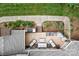 Aerial view of an outdoor patio featuring a built-in grill, ample seating, and lush landscaping at 2314 Winding Oaks Trl, Waxhaw, NC 28173