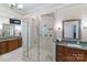 Modern bathroom with a glass shower, double sink vanity, and a large mirror at 2314 Winding Oaks Trl, Waxhaw, NC 28173