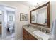 Neutral bathroom with a granite countertop, wood vanity, and adjacent toilet room at 2314 Winding Oaks Trl, Waxhaw, NC 28173