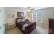 Comfortable bedroom with a ceiling fan, neutral decor, and large window at 2314 Winding Oaks Trl, Waxhaw, NC 28173