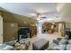 Spacious bonus room featuring carpeted floors, ceiling fans, and a cozy seating area with a television setup at 2314 Winding Oaks Trl, Waxhaw, NC 28173
