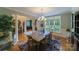 Elegant dining room featuring a large window for natural light and a stylish chandelier above the table at 2314 Winding Oaks Trl, Waxhaw, NC 28173