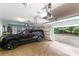 Well-lit garage with an SUV parked inside, featuring tiled flooring and an automated door system at 2314 Winding Oaks Trl, Waxhaw, NC 28173