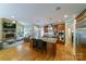 Beautiful kitchen with large island, stainless steel appliances, and a stone fireplace in the adjoining living space at 2314 Winding Oaks Trl, Waxhaw, NC 28173