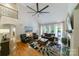 Spacious living room with hardwood floors, a ceiling fan, and natural light from large windows at 2314 Winding Oaks Trl, Waxhaw, NC 28173