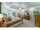 Large main bedroom with tray ceilings, sitting area, multiple windows, and a view to the backyard at 2314 Winding Oaks Trl, Waxhaw, NC 28173