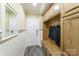 Well-organized mudroom with built-in storage, bench, and hooks for coats at 2314 Winding Oaks Trl, Waxhaw, NC 28173