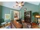 Inviting home office features a vaulted ceiling, hardwood floors, and large windows offering ample natural light at 2314 Winding Oaks Trl, Waxhaw, NC 28173