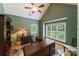 Inviting home office features a vaulted ceiling, hardwood floors, and large windows offering ample natural light at 2314 Winding Oaks Trl, Waxhaw, NC 28173