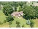 The aerial shot features a home surrounded by lush greenery and mature trees in a rural setting at 24008 Carriker Rd, Albemarle, NC 28001