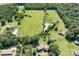 Stunning aerial view showcasing a sprawling estate featuring a pond and lush greenery at 24008 Carriker Rd, Albemarle, NC 28001