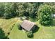 Aerial view of a secluded property featuring a shed or barn surrounded by mature trees and lush greenery at 24008 Carriker Rd, Albemarle, NC 28001