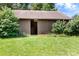 Exterior view of a wooden barn with open doorway and lush greenery surrounding it at 24008 Carriker Rd, Albemarle, NC 28001