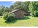 Exterior view of a wooden barn with green grass surrounding it and mature trees at 24008 Carriker Rd, Albemarle, NC 28001