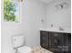 Bathroom featuring dark wood vanity with solid surface countertop and white fixtures at 24008 Carriker Rd, Albemarle, NC 28001
