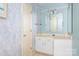 Bathroom with light blue walls, white vanity, and decorative mirror at 24008 Carriker Rd, Albemarle, NC 28001