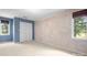 A carpeted bedroom features two windows and a neutral-colored accent wall at 24008 Carriker Rd, Albemarle, NC 28001