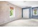 Bedroom with dual windows, a built-in bench, and neutral walls and carpet at 24008 Carriker Rd, Albemarle, NC 28001