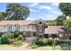 Charming Tudor-style home with brick and stucco accents, surrounded by mature landscaping and greenery at 24008 Carriker Rd, Albemarle, NC 28001