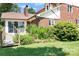The backyard features a well-kept lawn and landscaped garden beds around the house's edge at 24008 Carriker Rd, Albemarle, NC 28001