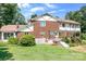 The exterior showcases a brick home with a deck, pergola, and well-maintained lawn at 24008 Carriker Rd, Albemarle, NC 28001