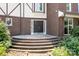 Elegant front entrance with a brick staircase, leading to a Tudor-style home with a welcoming facade at 24008 Carriker Rd, Albemarle, NC 28001